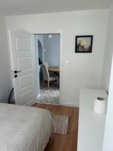 a bedroom with a bed and a dining room with a table at Pavels Cozy Nook in Smolyan