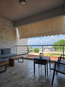 a living room with a couch and a table at Villa Mare Lux in Nea Fokea