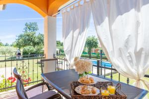 a table on a balcony with food on it at Villa Antonela in Radetići