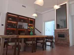 a dining room with a table and chairs and a fireplace at Dimora Villa Serena Porto Selvaggio Gallipoli in Gallipoli
