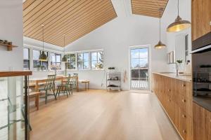 a kitchen and dining room with a table and chairs at 8569-Grenaa-Kystvej-3-b in Grenå Strand