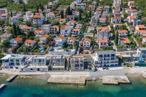 an aerial view of a city with houses and the water at Apartman Mafini in Krašići