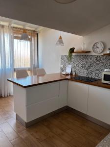 a kitchen with white cabinets and a counter top at Cuore Selargius in Selargius