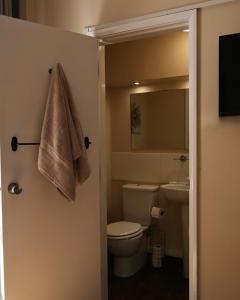 a bathroom with a toilet and a sink and a towel at The King's Head, Lanchester in Durham