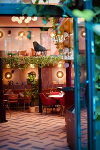 a restaurant with tables and chairs in a room at ClapClap Hôtel Strasbourg in Strasbourg