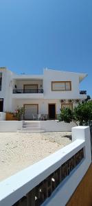 a large white house on the beach with a balcony at Villa Golden Coast - Lagos in Lagos