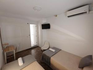 a room with two beds and a desk and a window at AYAMONTE ROOMS 43 in Ayamonte +56 photos