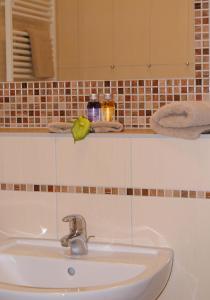 a white sink in a bathroom with a mirror at Apartment Romantik Flair in Prerow