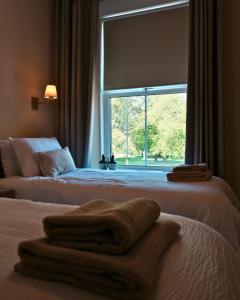 a bedroom with two beds and a large window at The King's Head, Lanchester in Durham