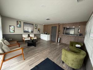 a large living room with chairs and a couch at Gateway Inn in Lake City