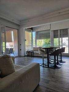 a living room with a couch and a table at Villa Mare Lux in Nea Fokea