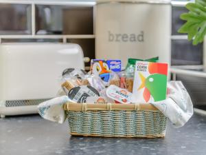 a basket of food and snacks on a counter at High Haven in Amble +15 photos