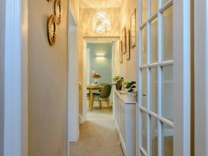 a hallway with a door leading to a dining room at High Haven in Amble