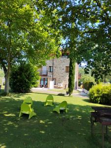 a group of green chairs sitting in the grass at Habitaciones amplias tipo Suite Durango in Guyuria