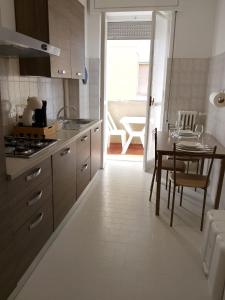 a kitchen with a table and a dining room at Beautiful Home Mxp in Gallarate