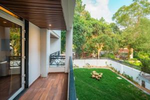 a view from the balcony of a house with a yard at Four Leaf Hotel Arjuna Manor, Varanasi in Varanasi