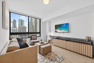 a living room with a couch and a large window at Downtown Miami Luxe 1BR! in Miami
