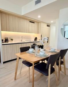 a dining room with a wooden table and chairs at Downtown Miami Luxe 1BR! in Miami