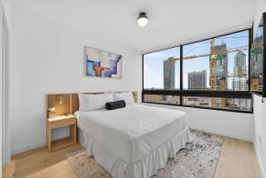 a bedroom with a bed and a large window at Downtown Miami Luxe 1BR! in Miami