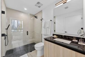 a bathroom with a toilet and a sink and a shower at Downtown Miami Luxe 1BR! in Miami