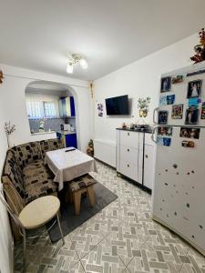a kitchen with a table and a refrigerator at Apartament Arys 2 in Neptun +4 photos