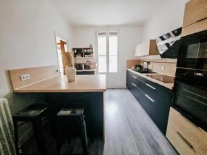 a kitchen with a counter and a sink and a table at Champagne getaway, spacious house in Épernay +30 photos