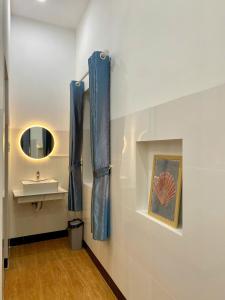 a bathroom with a sink and a mirror at CoCo SEA in Mui Ne +27 photos
