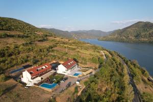 an aerial view of a house on a hill next to a river at Pensiunea Ecaterina in Berzasca