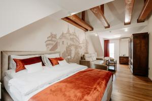 a bedroom with a large bed and a couch at Hotel Bojnický vínny dom in Bojnice +62 photos