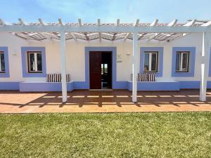 a white house with a porch and a door at O Monte da Estrada in Zambujeira do Mar