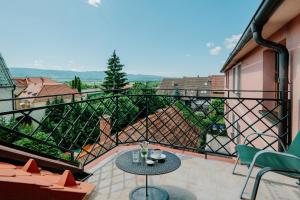 a balcony with a table and chairs and a view at Hotel Bojnický vínny dom in Bojnice