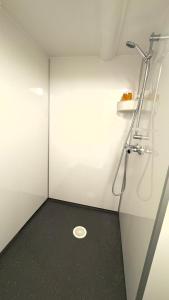a bathroom with a shower with a drain on the floor at ONS 2026 Economic Central accommodation in Stavanger