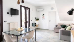 a living room with a glass table and a couch at CASA NICOLAS 158 by SalentoAffitti in Neviano