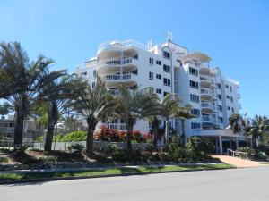 a large building with a large window overlooking a city at Beachside Resort Kawana Waters in Buddina