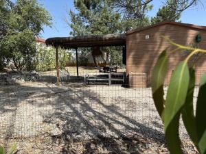 a shed with a fence in front of it at Casa Silvestre in Melides