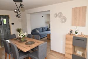a living room with a table and a blue couch at Kiki house in Čačak