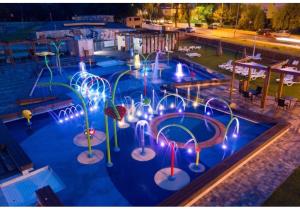 a swimming pool with a water park with a water slide at Studio w centrum in Turek