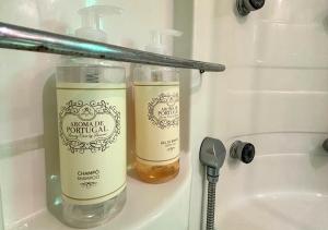 two bottles of soap sitting on a shelf next to a sink at Casa Silvestre in Melides +16 photos
