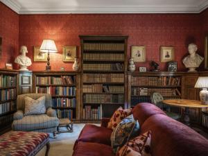 a living room filled with lots of books at Villa Abbotsford by Interhome in Darnick