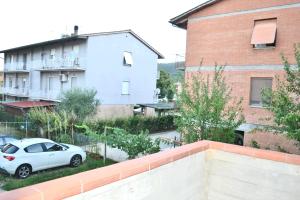 a white car parked in front of a building at Vicolo della Chiusa in Rosia