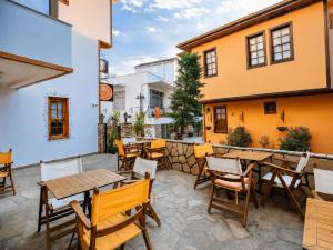 a patio with tables and chairs in a restaurant at Oldtown Patio in Antalya