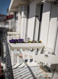 a white table with flowers on a balcony at Hotel l'etoile de la ville in Montecatini Terme