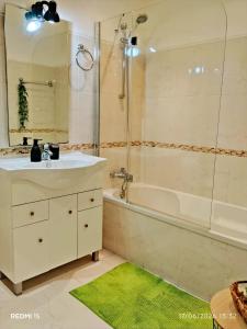 a bathroom with a sink and a tub and a mirror at Garden Luz House in Lagos +27 photos