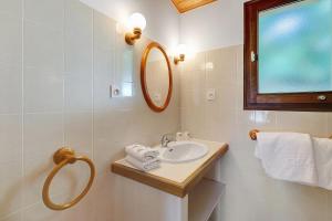a bathroom with a sink and a mirror and towels at Ferme Auberge Du Roc in Saint-Pompont +122 photos