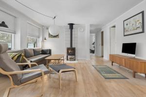 a living room with a couch and a fireplace at 1670-Melby-Kragesvej-36 in Melby