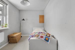 a bedroom with a bed with a quilt on it at 1670-Melby-Kragesvej-36 in Melby