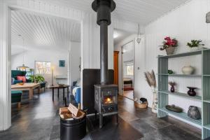 a living room with a wood stove in it at 8881-Glesborg-Benzonstien-27 in Fjellerup Strand
