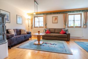 a living room with a couch and a table at Jägers Highlineblick in Breitenwang