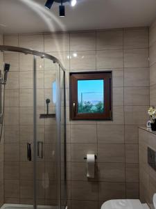 a bathroom with a shower and a window at Domki Stokrotka in Ruciane-Nida +16 photos