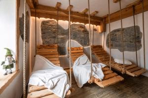 a room with two beds and a swing at Hotel Ristorante Milano in Vermiglio